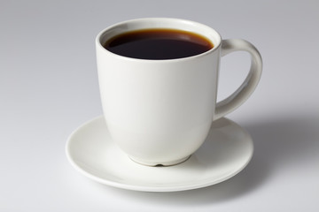 cup of coffee on bright gray background