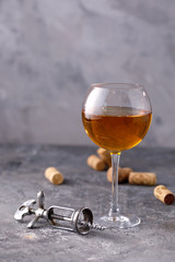 White wine in a glass. The concept of winemaking. Place under your text. Still life on a textural background.