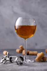 White wine in a glass. The concept of winemaking. Place under your text. Still life on a textural background.
