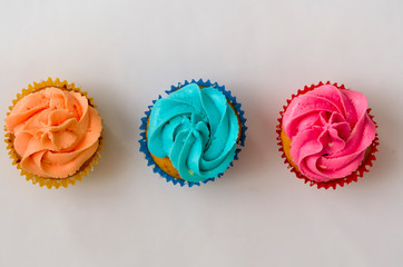 the Colorful homemade cupcakes on a white background