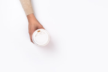 Female hand with paper cup isolated on white