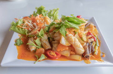 Close up of fried squid with salted eggs, Thai food.