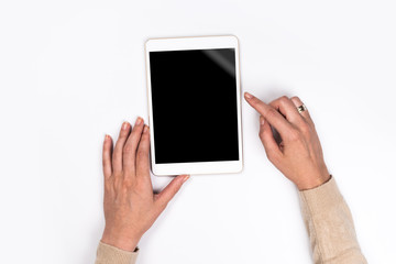 Closeup shot of  Woman's hands with perfect manicure  holding tablet, Empty display device. with clipping path.