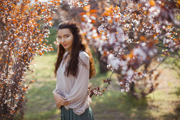 Woman Outdoors in Park Near Spring Blossom Tree