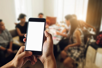 A man hand holding smart phone device in meeting room in morning light
