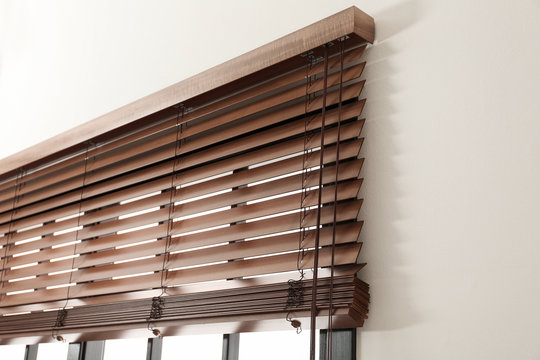 Fototapeta Modern window with stylish wooden blinds indoors