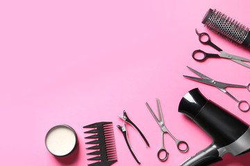 Fototapeta na wymiar Scissors and other hairdresser's accessories on pink background, flat lay. Space for text