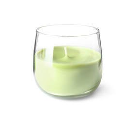 Green wax candle in glass holder isolated on white