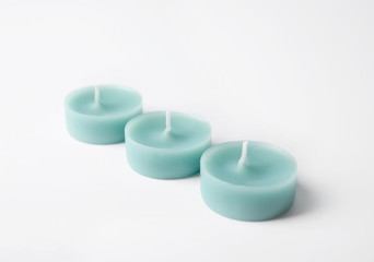 Light blue wax decorative candles isolated on white