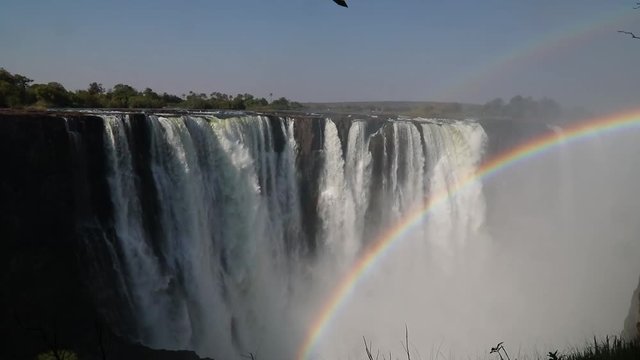 Magnificent Victoria Falls in Simbabwe with rainbox during dry season