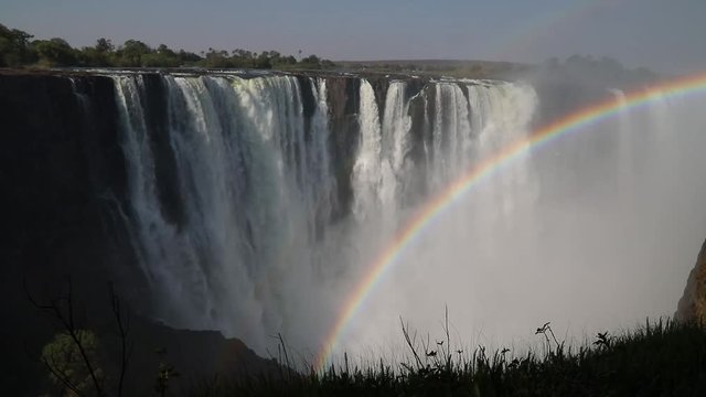 Magnificent Victoria Falls in Simbabwe with rainbox during dry season