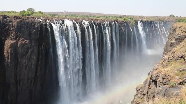 Magnificent Victoria Falls in Simbabwe with rainbox during dry season