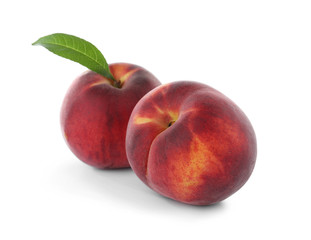 Delicious ripe peaches with leaf isolated on white