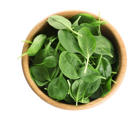 Wooden bowl of fresh green healthy baby spinach on white background, top view