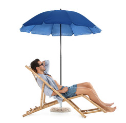 Young man on sun lounger under umbrella against white background. Beach accessories