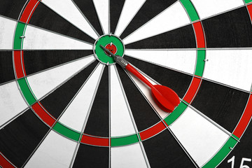 Closeup of dart board with color arrow, top view