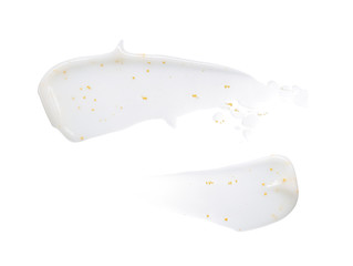Smears and texture of white face cream with yellow peas on a white background