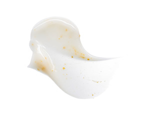 Smears and texture of white face cream with yellow peas on a white background