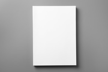 Stack of blank paper sheets for brochure on grey background, top view. Mock up