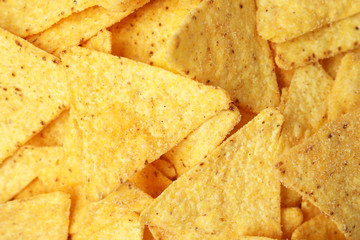 Tasty Mexican nachos chips as background, top view