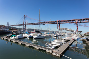 Fototapeta premium Lisbon, Portugal, Europe - View of Lisbon cityscape with typical tram, flag and Tejo River