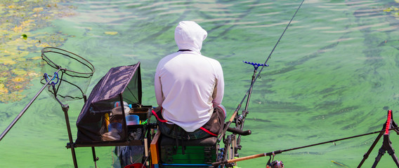 man fishes in the river on a fishing tournament