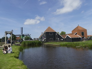 Fototapeta na wymiar Windmills by the water. Authentic town. The old town in Holland.