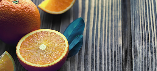 Orange citrus fruit on a stone table. Orange background.