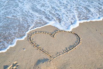 Love message on the beach sand - vacation and travel concep