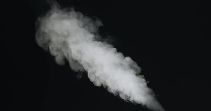 Slow motion of water vapor stream comes from below over black background