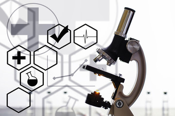 Research laboratory. Test tubes and microscope on the table. Double exposure.