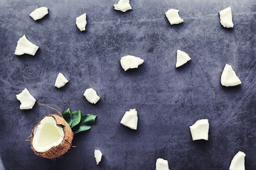Coconut on a dark stone table. Coconut oil.