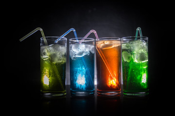 collection of colorful shots with lemon on bar; set of alcohol mini cocktail shooters with lime;