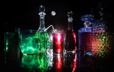 collection of colorful shots with lemon on bar; set of alcohol mini cocktail shooters with lime;