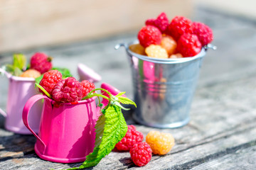 Ripe sweet raspberries on wooden table. Close up, top view, high resolution product.