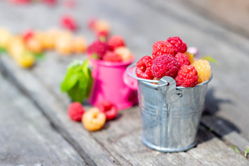 Ripe sweet raspberries on wooden table. Close up, top view, high resolution product.