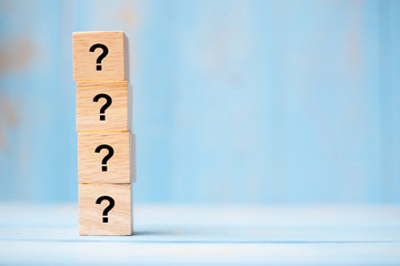 Questions Mark ( ? ) word with wooden cube block on blue table background. FAQ( frequency asked questions), Answer, Q&A, Information, Communication and Brainstorming Concepts