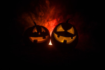 Group of Halloween Jack o Lanterns at night with a rustic dark foggy toned background