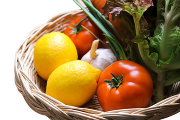 Mixed Fresh colorful vegetables in a wicker basket include Lemon salad tomato garlic carrot Scallion close up