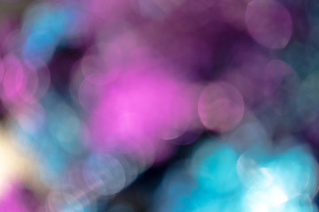 Background made of yellow, pink and blue blurred sparkles with copy space