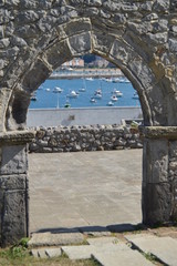 Arch of the beautiful collapsed wall of the church of San Pedro overlooking the fishing port on the Paseo Maritimo in Castrourdiales. August 27, 2013. Castrourdiales, Cantabria, Spain.