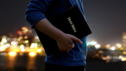 man carrying a Bible at his side