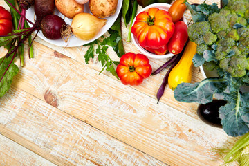 Fresh colorful organic vegetables from above. Top view, flat lay. Different vegetables for eating healthy on wooden background. Clean eating food frame. Copy space. Vegetarian, vegan..