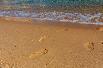 Human footprints on the sandy beach. Summer vacation concept