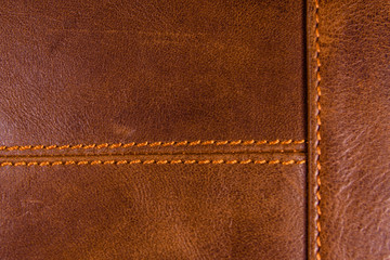 Texture of the natural brown leather and stitches