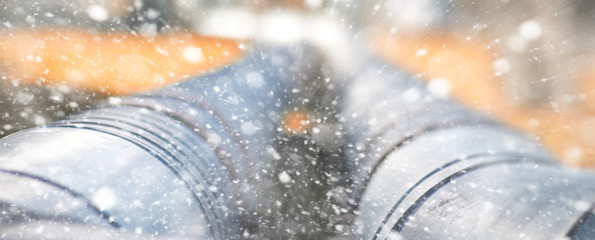 Metal pipeline in the street on a snowy day