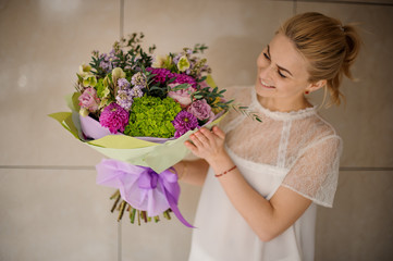 Girl holds bouquet of asters and lilac