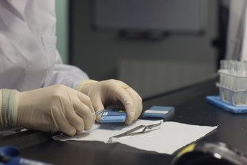 Preparation of samples under fume cabinets in order to analyse them in an Analytical Transmission Electron Microscope (ATEM), stage of positionning sample on ATEM grids, asbestos laboratory