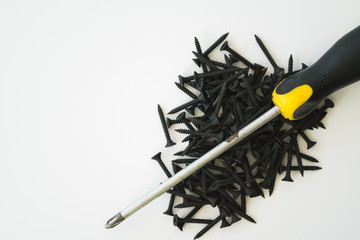 Black screws of self-tapping screws of same sizes isolated on white background.