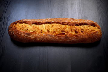 French bread baguette on vintage wooden background, breakfast concept